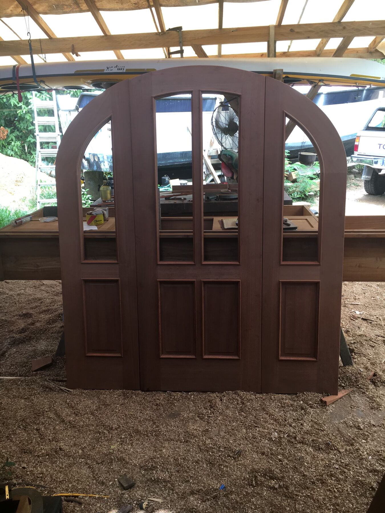 Arched mahogany double doors under construction in the Coral Bay shop